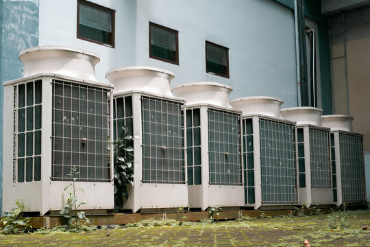 View of exterior VRV air conditioning units, extraction and insufflation, HVAC system, next to the building yard. 