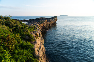 idyllic seascape with cliff and an island at Saeseom Island in Jeju Island, South Korea