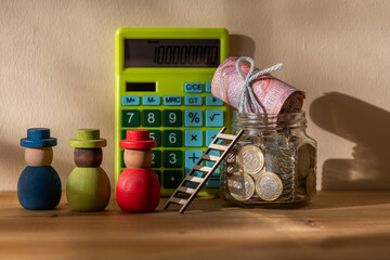 5,000 Kazakhstani tenge banknotes and a glass jar with 100 tenge coins 