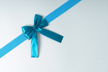 blue ribbon bow on white background suitable for birthday, celebration and social media purposes.