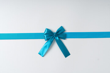blue ribbon bow on white background suitable for birthday, celebration and social media purposes.