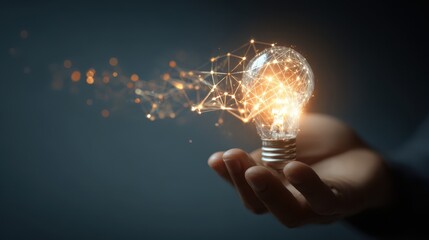 Hand holding a glowing light bulb with digital network connections, concept of innovation and technology
