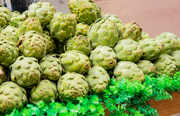 ripe organic artichokes ready for sale at an outdoor vegetable bazaar