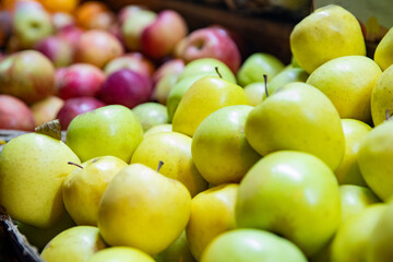 fresh juicy green and red apples on a farmhouse market counter