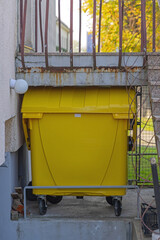 Yellow Plastic Recycling Bin Hidden Under Stairway Building Waste Sorting