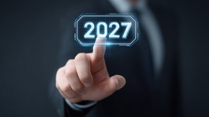 Fototapeta premium Businessman in Suit Touching Digital Screen Display with Virtual Year 2027 as Concept of Future Planning and Innovation in Corporate Environment