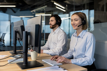 Professional call center agents in headsets collaborating at computers in a modern office, delivering friendly customer support, teamwork and efficient communication for clients