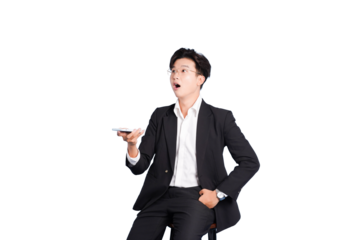 Astonished Businessman: A dapper businessman in a formal suit displays a look of disbelief and surprise as he holds a device in his hand. Perfect for illustrating a moment of shock or astonishment. 