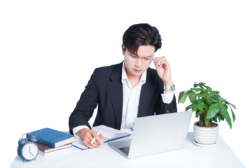 Focused Professional at Desk: A concentrated professional, immersed in work at his desk, meticulously reviews notes and a laptop, with a pen in hand, suggesting dedicated focus and diligent analysis.