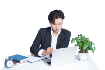 Focused Professional at Desk: A concentrated professional, dressed in smart attire, navigates a laptop at a neat desk, alongside books and a potted plant, signifying focus and productivity.