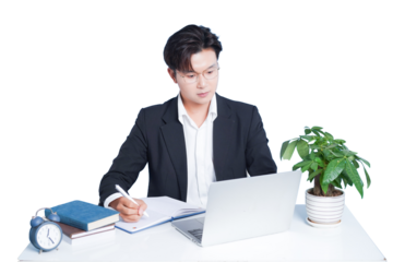 Focused Professional at Work: A diligent professional in a modern office setting is completely engrossed in his task, diligently jotting down notes while attentively utilizing a laptop.