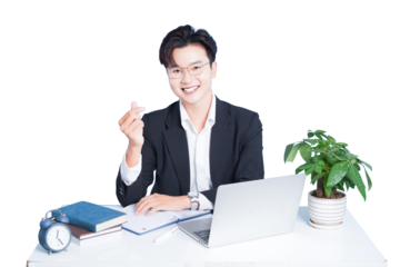 Smiling Office Worker Gesture: A cheerful office worker, adorned in a sophisticated suit and spectacles, offers a gesture of affection at a tidy desk, with an open laptop, a potted plant.