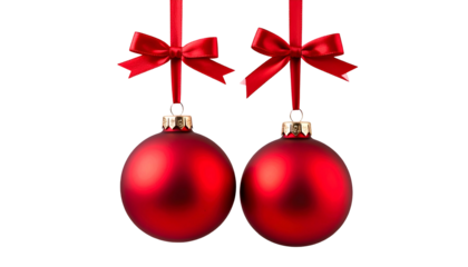 Two round, red Christmas ornaments, suspended by satin bows against a black backdrop