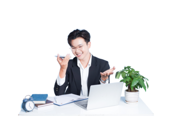 Professional Engaged in Communication: A focused young professional, dressed in a formal suit, is actively engaged in a lively conversation using his phone, set at a clean desk with laptop and decor.