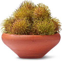 clay bowl of fresh green and yellow rambutans isolated white background, side view in close-up