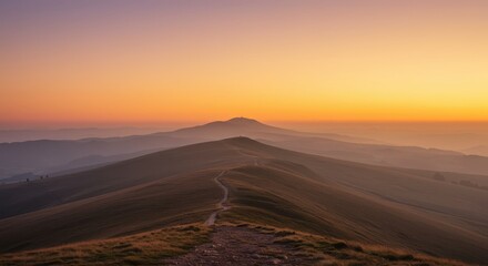 Serene mountain ridge path unfolds towards distant peaks during warm sunset