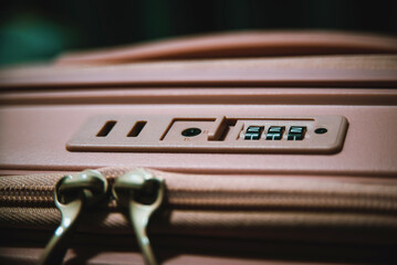 Close up of suitcase lock with security code on travel luggage, safety and protection concept for secure travel and baggage protection