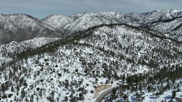 Snow Covered San Gabriel Mountains Road Aerial Shot Descend Forward California USA