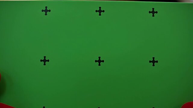 afro woman in red coat and santa hat holding green card in gift shop chromakey
