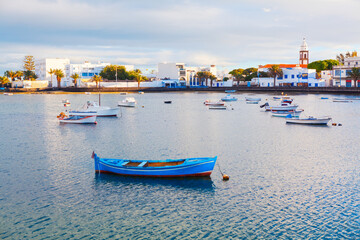 Fototapeta premium Charco de San Gines, lagoon and urban harbor in Arrecife, capital of Lanzarote in Canary Islands, Spain. Scenic area whit fishermen cottages and promenade with bars and restaurants, moored small boats