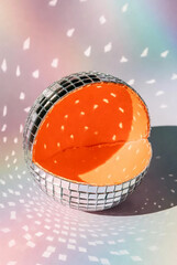 Surreal Disco Orange: Sliced Citrus Mirror Ball with Retro Rainbow Lighting