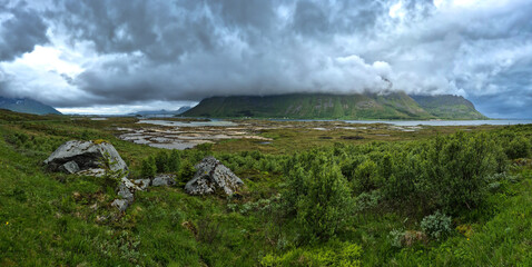 Cloudy Mountains And Calm Fjord With Bridge On Lofoten Islands In Norway