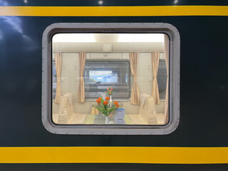 The dining car window of a green train on China's railway