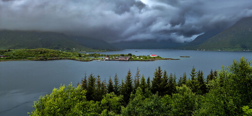 Rural Landscape With Remote Village, Calm Fjord And Foggy Mountains On Lofoten Islands In Norway