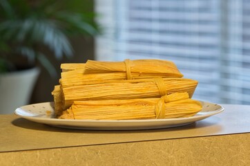 Fresh tamales on plate Mexican food Hispanic cooking domestic household countertop.