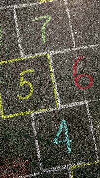 Bright Chalk Lines On City Pavement Evoke Joy, Summer Memories Of Kids Hopping And Drawing On Sidewalks