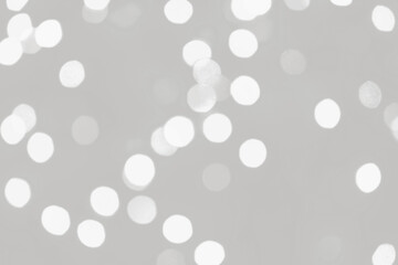 Cloud dancer lights bokeh background, Chrismas lights bokeh. Monochrome abstract background. Blurred and glowing lights. Cloud dancer bokeh lens effect from lighting spots.