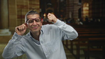Man in a church setting making a gesture of crying, conveying emotion and drama against a backdrop...