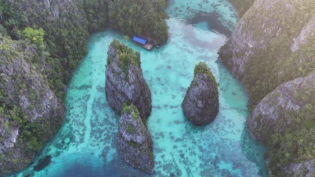 Rock islands, composed of ancient, uplifted reefs, rise from the seascape in Misool, Indonesia. This region harbors spectacular marine biodiversity and is a popular diving destination.