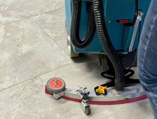 Teal Rideon Scrubber Thoroughly Cleaning Glossy Tile Surfaces, Professional Cleaning Team Utilizes...