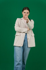 young woman pointing forward at camera with both fingers and angry expression, telling you to do your duty against white background. High quality photo