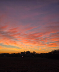 Fototapeta premium sunset over a small village, dramatic sky