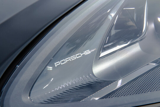 October 9, 2021, Seoul, South Korea - A close-up of the Porsche logo inside the headlight of a Porsche Macan S luxury SUV.