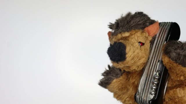 A toy hedgehog trying to open a swiss army knife. Perfect for concepts of problem-solving, utility, camping, or DIY projects.
