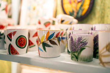 Handmade ceramic mugs with colorful hand painted patterns.