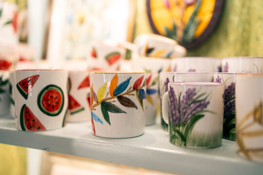 Handmade ceramic mugs with colorful hand painted patterns.