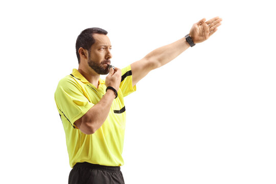 Football referee blowing a whistle and showing offside
