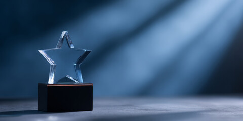 A glass star award on a wooden base is highlighted by beams of light in the background