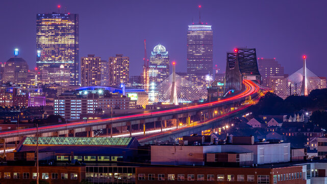 Aerial view of Boston in Massachusetts, USA at night showcasing its skyscrapers and the famous Tobin bridge.