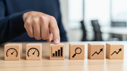Business Growth and Performance Improvement Concept. Wooden blocks with analytics and performance icons, representing performance review and data driven business evaluation.
