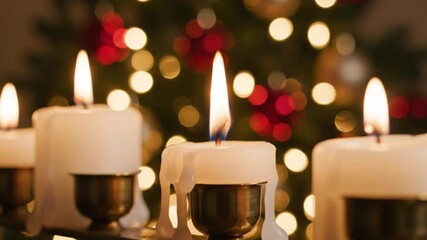Warm and inviting a close up of softly glowing white candles with a blurred festive background