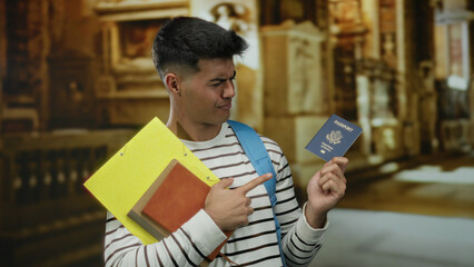 Young man holding a united states passport and pointing at it inside a church setting with books, showcasing travel and education themes. © Krakenimages.com