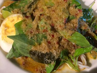 Thai Rice Noodles in spicy Fish curry. Kanom Cheen Num Ya ,Fresh Thai rice noodle and a fish based sauce, Served with vegetables, dried chillies and basil. Thai food