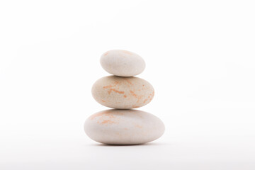 Balanced stack of three smooth river rocks resting on each other. Perfect for Zen balance, meditation, or spa concepts.