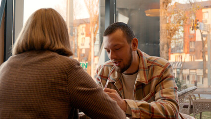Couple sitting and talking in a cozy cafe