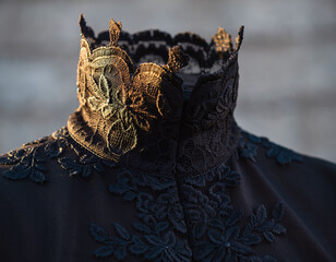 Intricate black lace highcollar glows in golden light, evoking a sense of mystery and vintage luxury. Ideal for fashion editorials, historical concepts, and highend design projects.